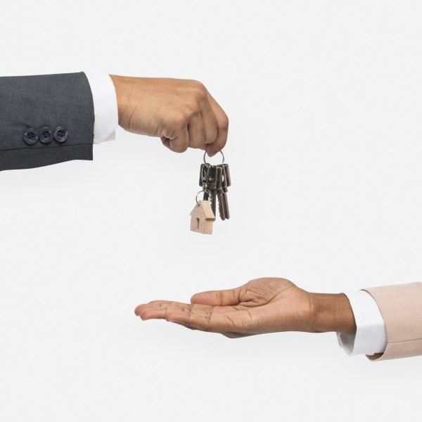 Hand giving key  real estate agent